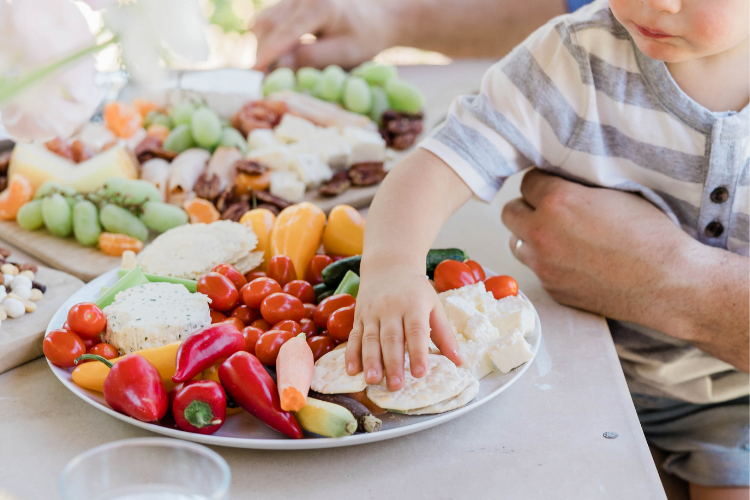 Influencing childrens eating 3 toddler grabbing food from a plate of mixed foods