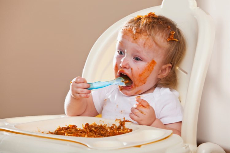 Influencing childrens eating 4 messy toddler with spaghetti over face and hair