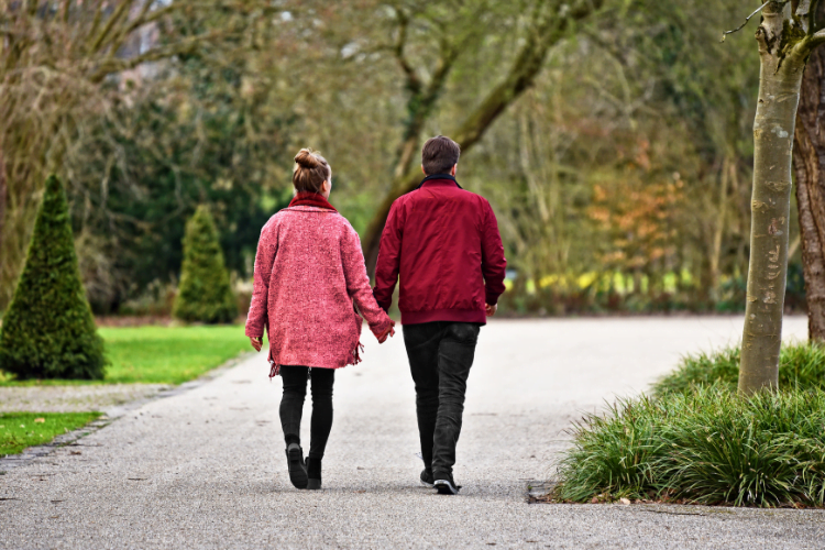 no smoking 3 couple holding hands walking outside