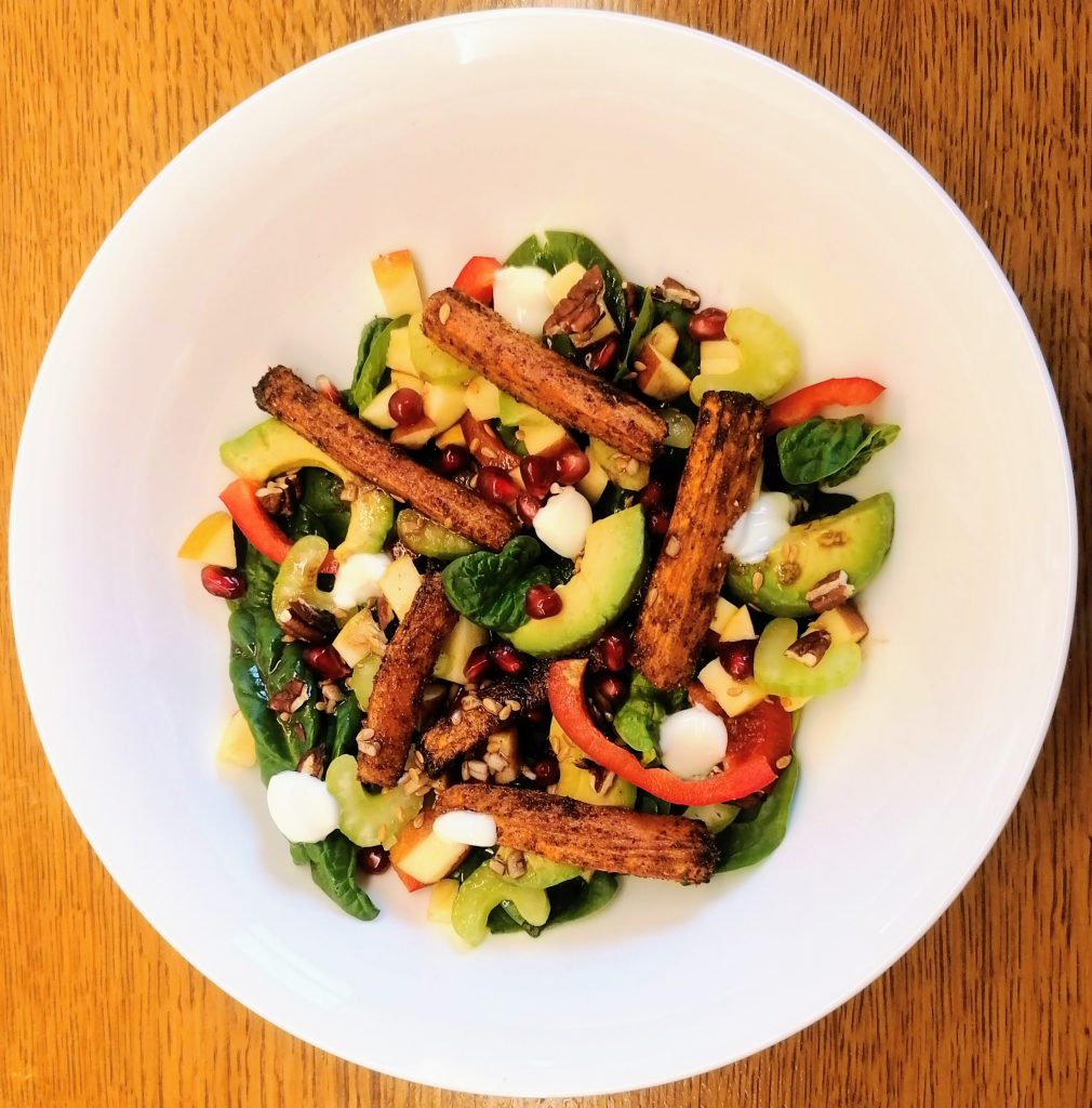 a bowl full of carrot and avocado salad
