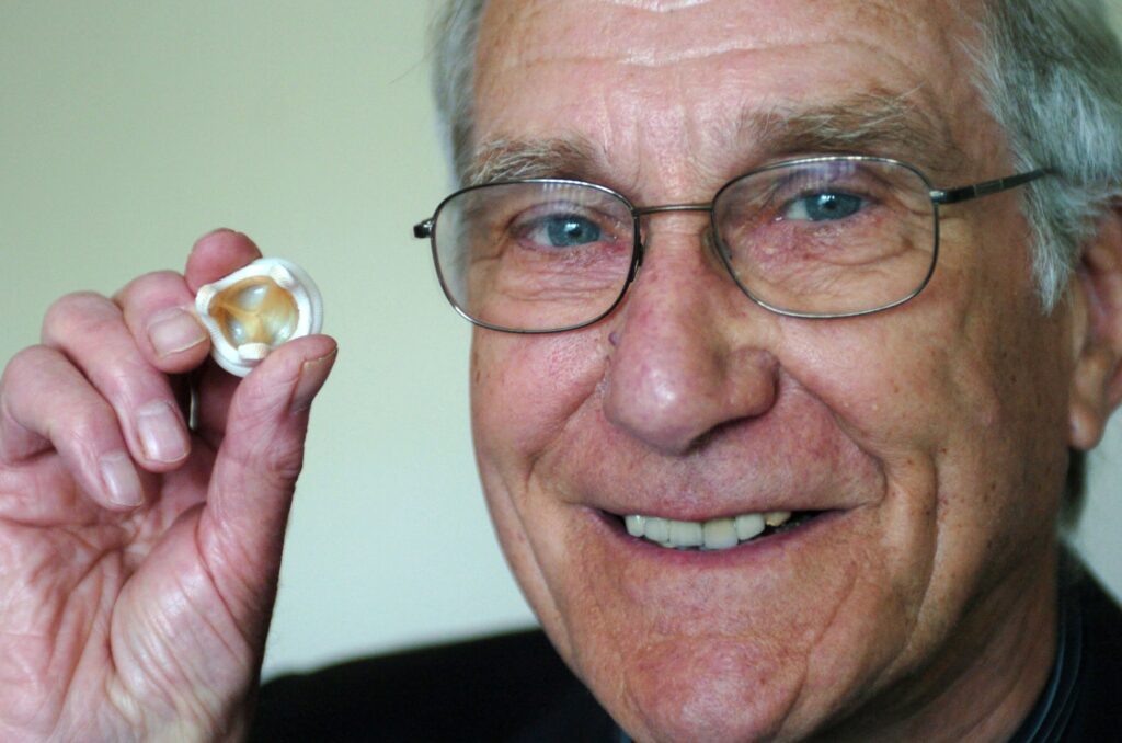 Founder of Heart Research UK, David Watson holding a heart valve