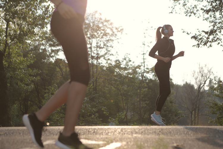 two white women warming up for a jog