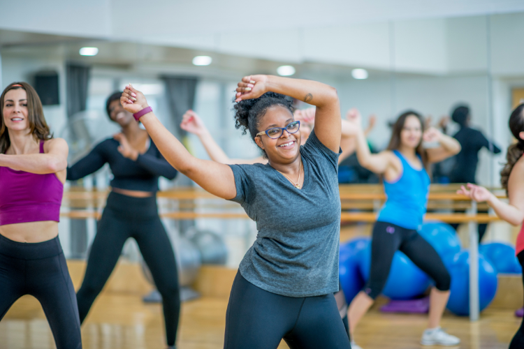 women doing exercise class looking happy