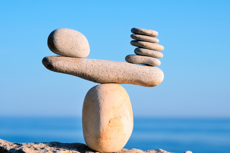 01 stone balancing on top of one another perfectly on a beach