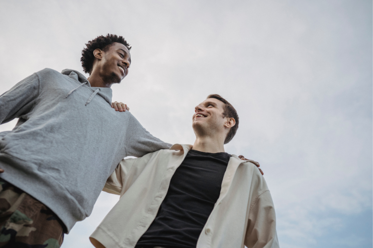 02 two males hugging one another