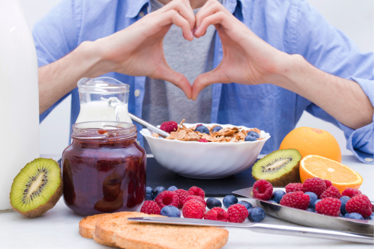 03 a-person-making-a-heart-shape-with-their-hands-over-healthy-foods