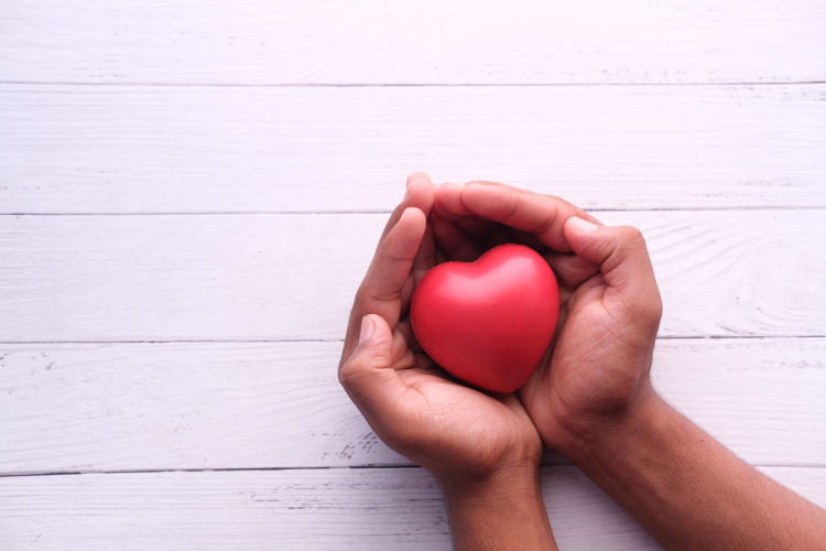 two-hands-holding-a-heart-shaped-ball