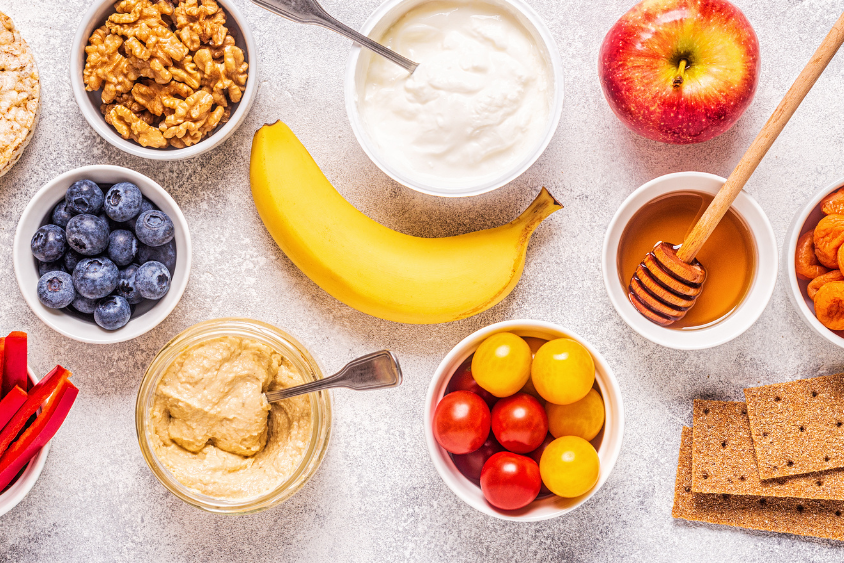 Holidays 1 Mix of bananas, pot of honey, apple, blueberries in a bowl, bowl of granola