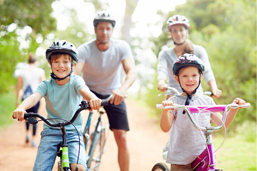 Holidays 2 Family of four on bikes, white male, female and children