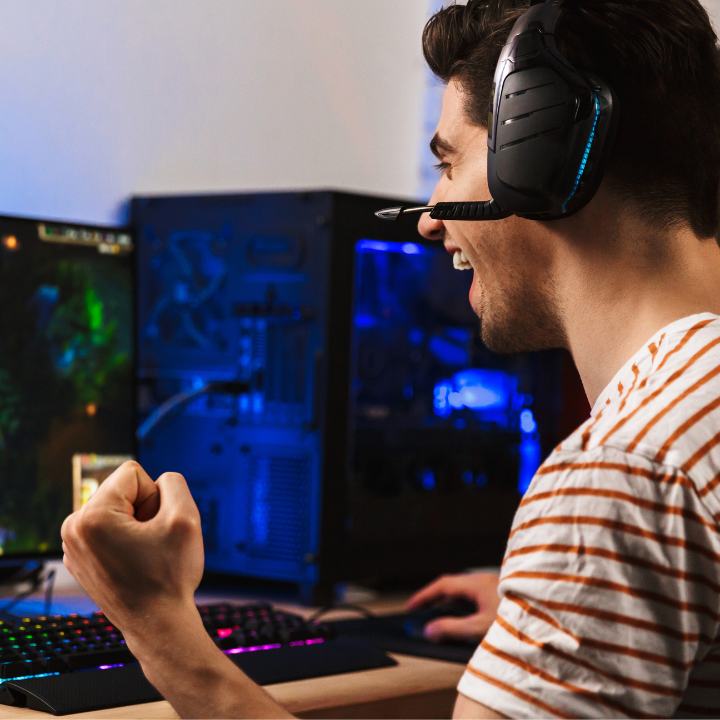 person playing game on computer wearing headset