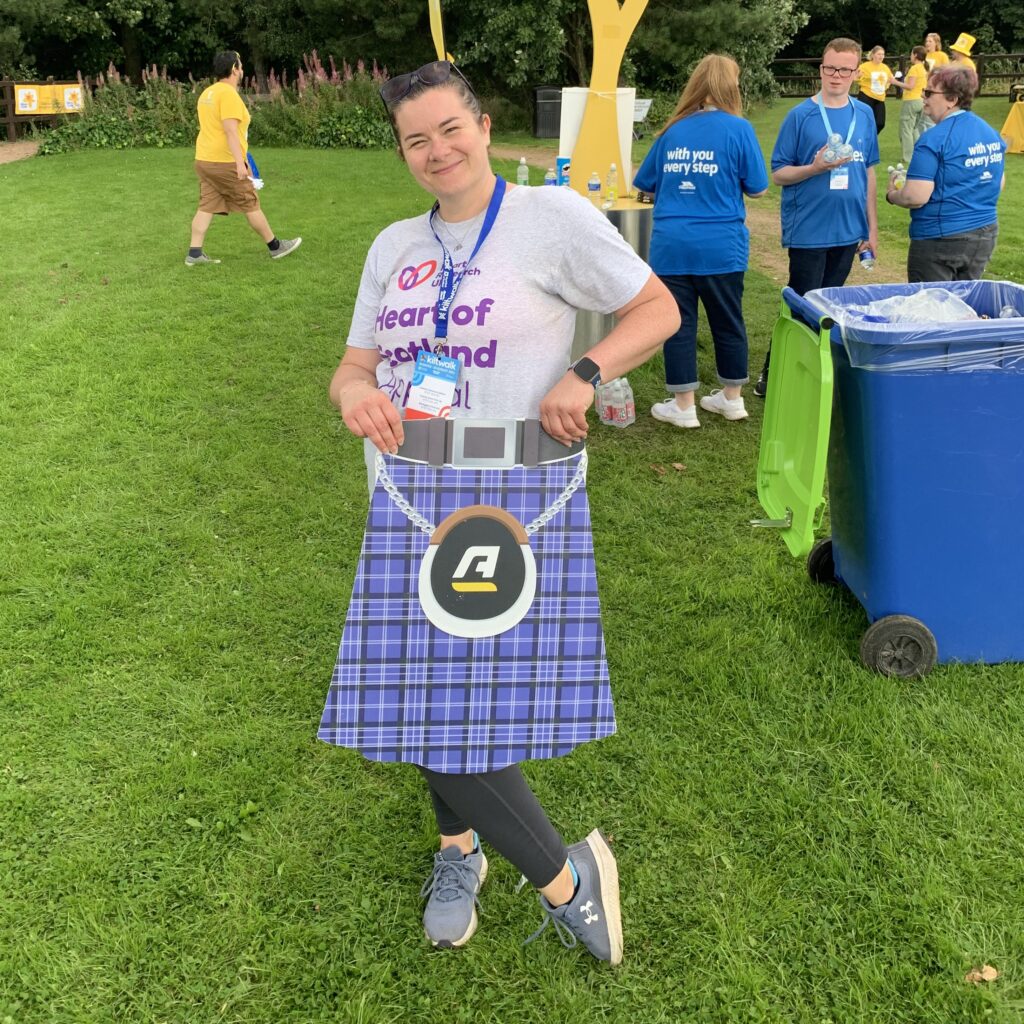 Vicki Kilt crop Woman in HRUK t-shirt holding a cardboard kilt in front of her