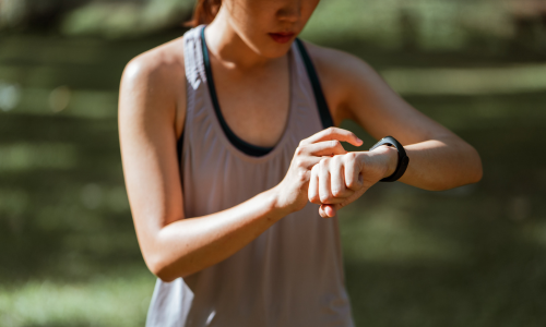 fitness tracker person checking their fitness tracker watch