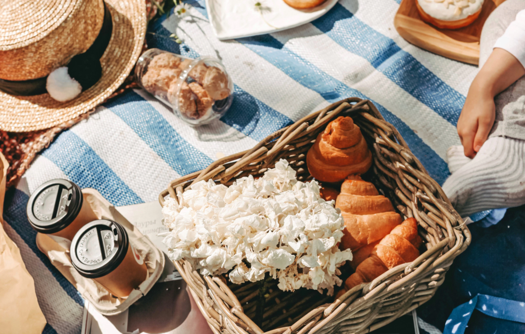 jam and other food on a picnic blanket