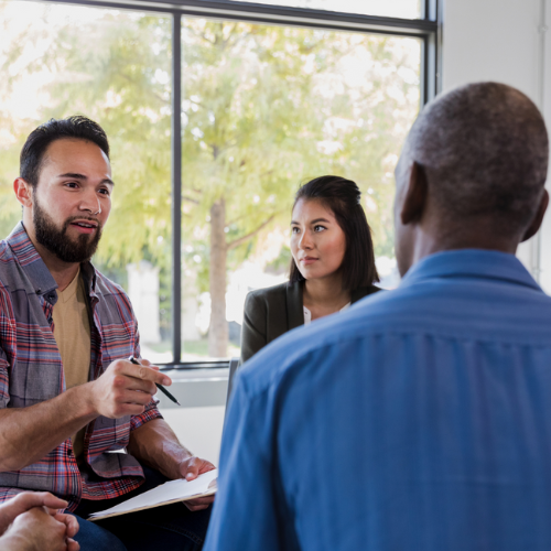 Group of three people talking
